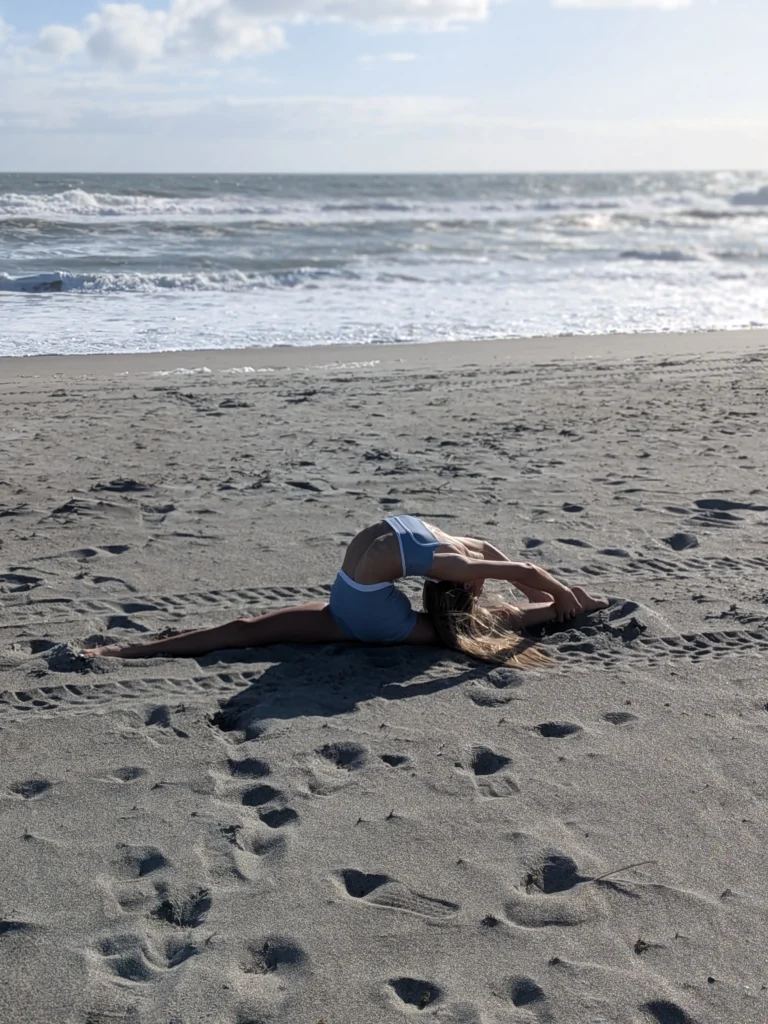 Kinsley stretching in a split on the sand
